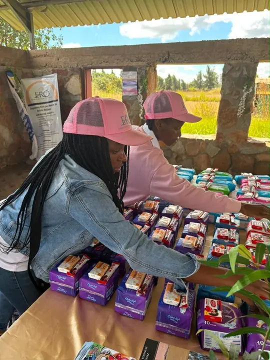 Volunteers arrange care packs on a table during an ERO programme