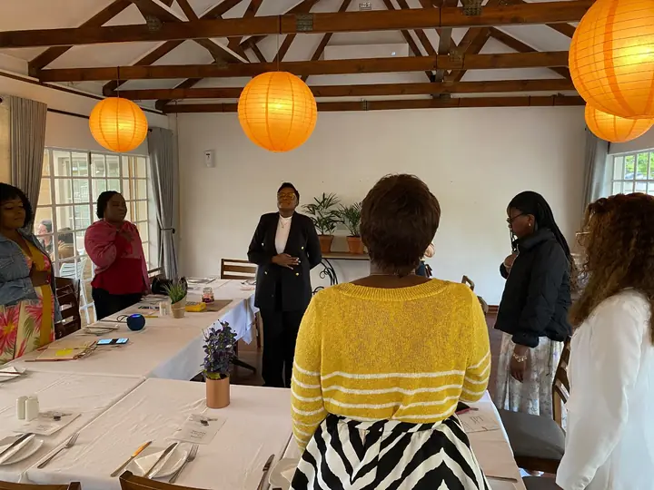 A facilitator leads an adult workshop in a meeting room