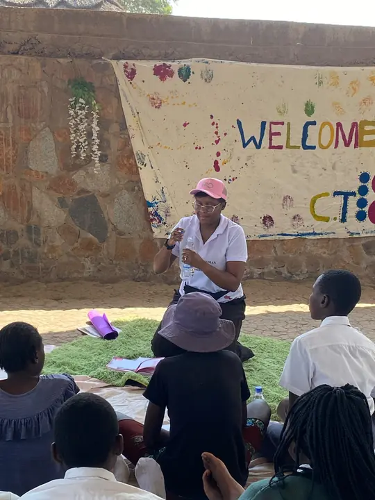 An ERO facilitator speaks with a seated group of students.